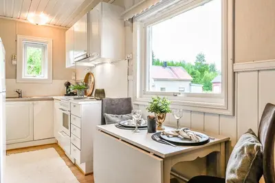 a kitchen with a table and a window at The Blue Cabin in Trysil