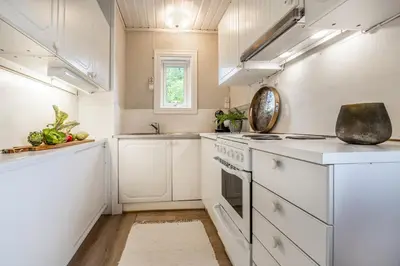a kitchen with white appliances and a window at The Blue Cabin in Trysil