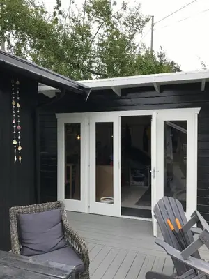 a screened in porch with two chairs on a deck at Cabin With Views Over Straumsundet in Øygarden