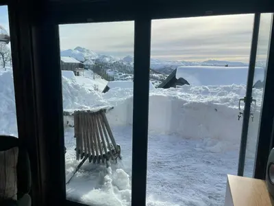 a view of a snow covered yard from a window at Modern Cabin With Mountain Views In Rauland in Rauland