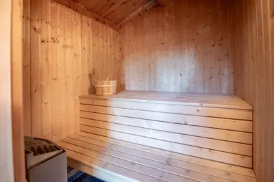 a wooden sauna with a bucket in it at Lisetra 716B in Trysil