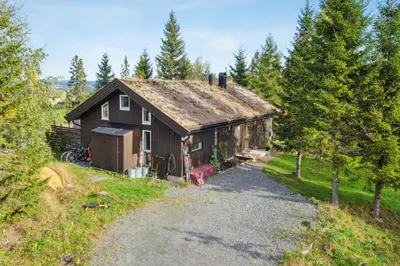 a house on a hill with a gravel road at Family Cabin With Views Over Hadeland in Lunner