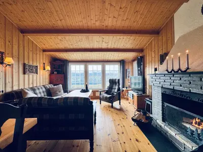 a living room with a couch and a fireplace at Fjellro-Geilo Cabin Retreat in Geilo