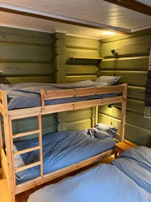 two bunk beds in a room with green walls at Log cabin at Hafjell in Øyer