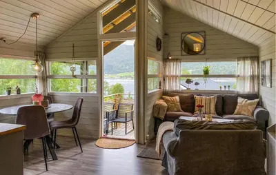 a living room with a couch and a table at Gorgeous Home In Lavik With House Sea View in Lavik