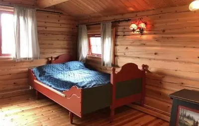 a bedroom with a bed in a log cabin at Stunning Home In Oppdal With Sauna in Oppdal