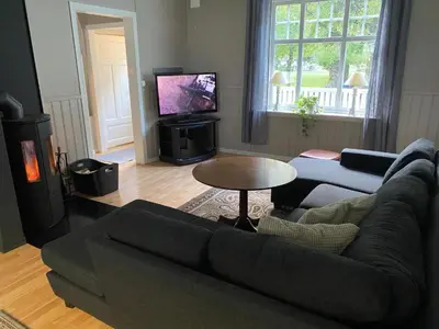 a living room with a couch and a tv at Tveitopark Apartments B in Rjukan