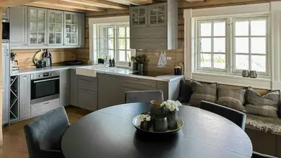 a kitchen with a table and chairs and a couch at Log Cabin With Panoramic Views At Voss Resort in Skulestadmo