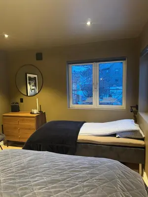 a bedroom with a bed and a window at Trolltunga Stay in Odda