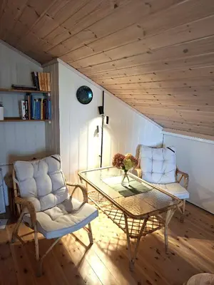 two chairs and a glass table in a room at Moderne hytte på Tingvoll nær sjø og turterreng in Tingvoll