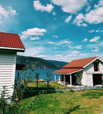 two houses with a view of a lake at Charming house by the fjord in Utvik