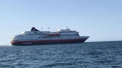 a cruise ship in the ocean on the water at Cabin with stunning views and outdoor jacuzzie in Leset