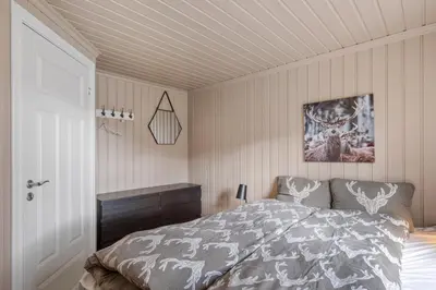 a bedroom with a bed and a dresser in it at Lingåsen Panorama! in Valldal