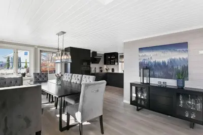 a kitchen and dining room with a table and chairs at Lingåsen Panorama! in Valldal