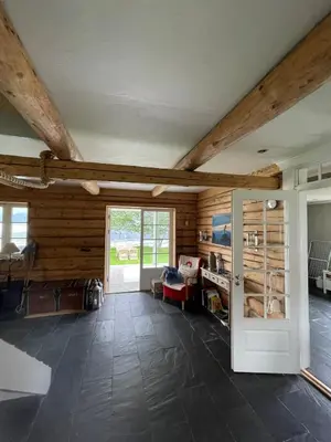 a living room with wooden walls and a large window at House with oceanview in Stryn