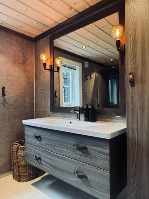 a bathroom with a sink and a mirror at Spacious cabin in the mountains in Gol