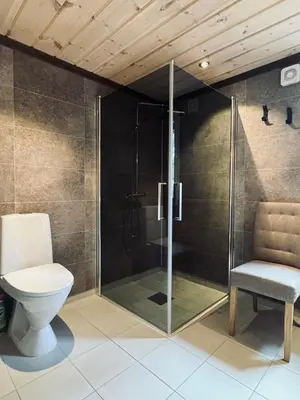 a bathroom with a shower and a toilet at Spacious cabin in the mountains in Gol