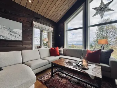 a living room with a couch and a table at Spacious cabin in the mountains in Gol