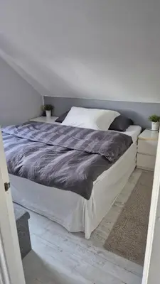 a bedroom with a large bed in a room at Charming family house with beautiful views! in Askøy