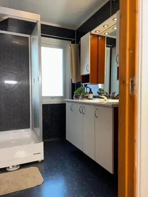 a kitchen with a sink and a shower at 3 soveroms leilighet-komfort og stil -perfekt for ferie og jobb in Gjøvik
