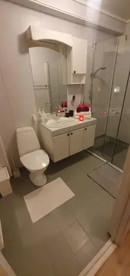 a bathroom with a toilet and a sink and a shower at Fotlandsvåg Guest Apartment in Bernes
