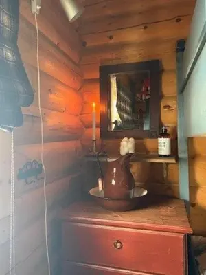 a room with a tea kettle on a dresser with a mirror at Timber Cabin With Wood-Fired Hot Tub In Trysil in Trysil