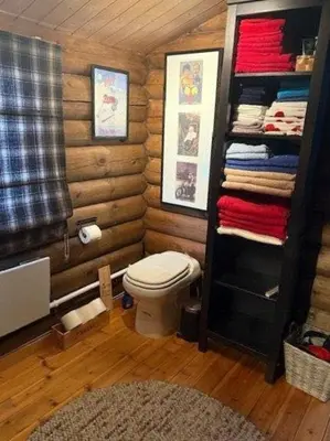 a small bathroom with a toilet and towels at Timber Cabin With Wood-Fired Hot Tub In Trysil in Trysil