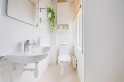a white bathroom with a sink and a toilet at Apartment Bergen Center - Quiet Gem - Norwegians Minimum Age 25 in Bergen