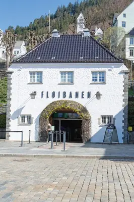 a white building with an archway in front of it at Bergen City Retreat - Steps from Bryggen - Norwegians Minimum Age 25 in Bergen