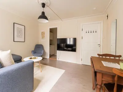 a living room with a couch and a table at Bergen City Retreat - Steps from Bryggen - Norwegians Minimum Age 25 in Bergen