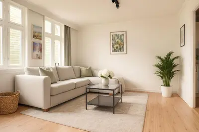 a living room with a white couch and a table at Delightful Bryggen Apartment - Norwegians Minimum Age 25 in Bergen