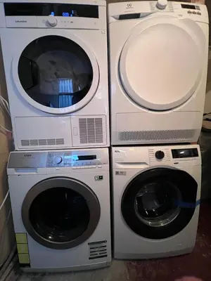 two washing machines and a dryer next to each other at Delightful Bryggen Apartment - Norwegians Minimum Age 25 in Bergen