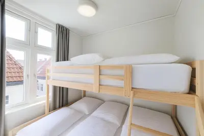 two bunk beds in a room with a window at Trio Central in centre - Norwegians Minimum Age 25 in Bergen