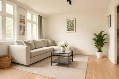a living room with a white couch and a table at Quartet Bryggen Central - Quiet and Cozy - Norwegians Minimum Age 25 in Bergen