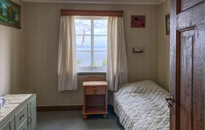 a small bedroom with a bed and a window at Lovely Home In Fiksdalen in Fiksdal