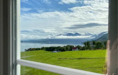 a view from a window of a field and a lake at Lovely Home In Fiksdalen in Fiksdal