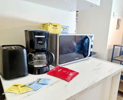 a kitchen counter with a coffee maker and a microwave at Renovated retreat in beautiful area near Bryggen in Bergen