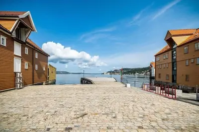 a cobblestone street next to a body of water at Renovated retreat in beautiful area near Bryggen in Bergen