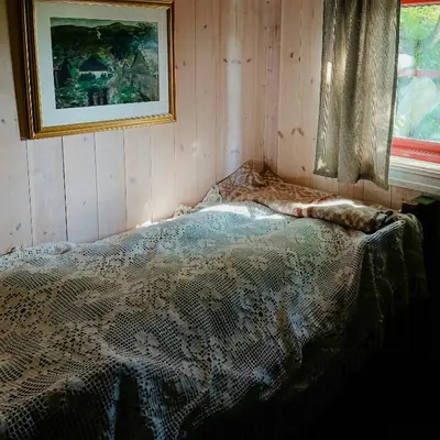 a bed in a room with a picture on the wall at Restored Cabin From 1852 In Bergsjø Area in Ål