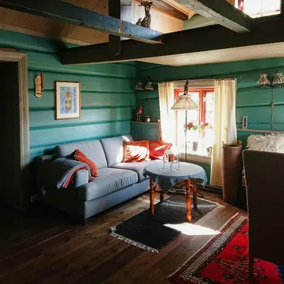 a living room with a couch and a table at Restored Cabin From 1852 In Bergsjø Area in Ål
