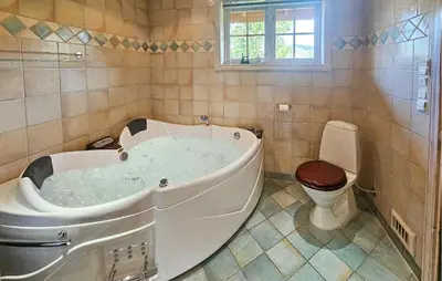 a bath tub in a bathroom with a toilet at Awesome Home In Eggedal With Sauna in Eggedal
