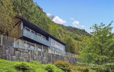 a building on top of a stone wall at Awesome Home In Eidfjord With House Sea View in Eidfjord