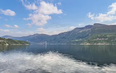 a bridge over a large body of water with mountains at Awesome Home In Eidfjord With House Sea View in Eidfjord