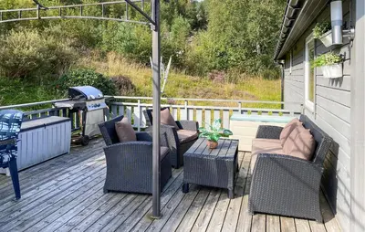 a patio with chairs and an umbrella on a deck at Stunning Home In Korssund With Wifi in Korssund