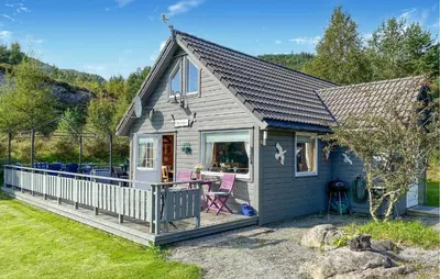 a tiny house with a deck and a patio at Stunning Home In Korssund With Wifi in Korssund