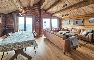 a living room with a table and couches in a cabin at Nice Home In Gol With Sauna in Gol