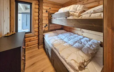a bedroom with two bunk beds in a log cabin at Nice Home In Gol With Sauna in Gol