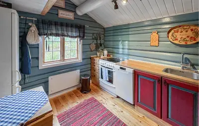 a kitchen with green walls and a stove and a sink at 4 Bedroom Lovely Home In Nord-Torpa - N31585 in Nord Torpa
