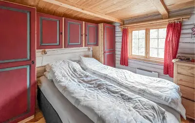 a large bed in a room with a red door at 4 Bedroom Lovely Home In Nord-Torpa - N31585 in Nord Torpa