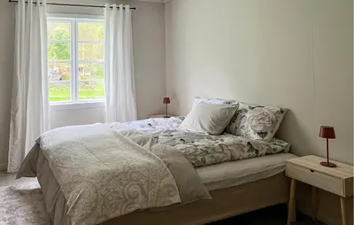 a bed in a bedroom with a window at Gorgeous Home In Eikesdal - N28170 in Verma